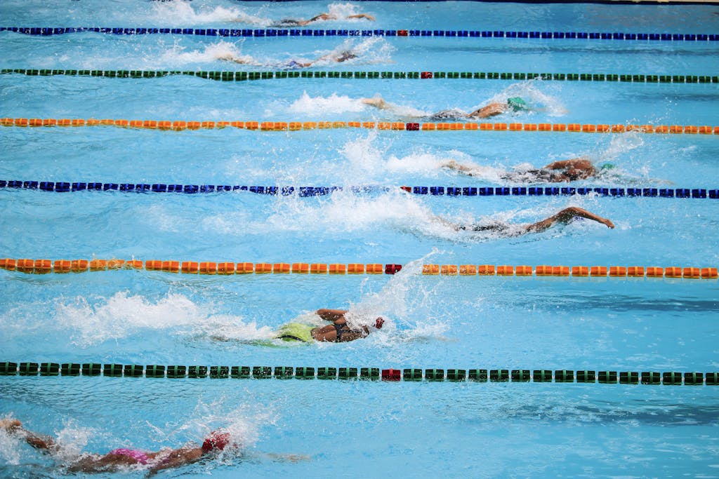 Photo by Jim De Ramos Swimmers compete in an outdoor pool race, showcasing athleticism and sportsmanship.